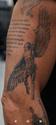 a man with a tattoo on his arm holding a bird in one hand and an arrow in the other