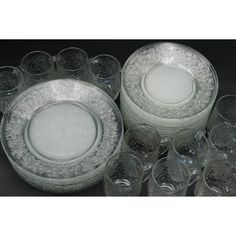 an assortment of glass dishes and glasses on a table