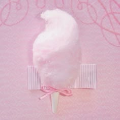 a cotton candy lollypop on a pink background