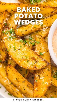 baked potato wedges with parmesan cheese and herbs on the side in a white bowl