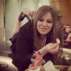 a woman sitting at a table eating food