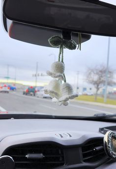 the interior of a car with flowers hanging from it's dash board