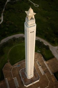 an aerial view of a tall white building with a star on it's top