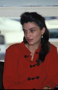 a woman sitting next to a man in a red shirt