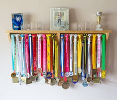 Orders placed now will be sent out in the new year (see the expected delivery date on the listing).  Have a very Happy Christmas!! Medal Hanger Holder Display Rack Shelf for Trophies Display your Medal and trophies, framed race photos, bib with pride! Choice of 4 sizes.  (width 40cm, 60cm, 80cm or 100cm)  Handmade in the UK from FSC certified redwood timber.  Supplied with quality multi-purpose wall fixings to suit brick or plasterboard  Made in the UK by a runner for a runner An ideal gift for Sports Medal Display, Running Medal Display, Gymnastics Medals, Running Medal Holder, Trophy Shelf, Medal Rack, Trophy Display, Race Medal, Running Medals