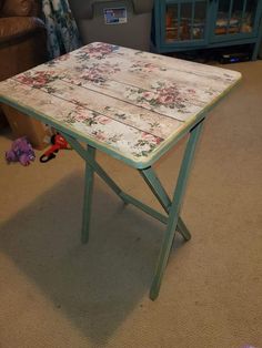 a small table with flowers on it in a living room