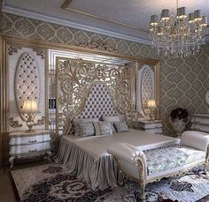 a fancy bedroom with white furniture and chandelier hanging from the ceiling, along with carpeted flooring