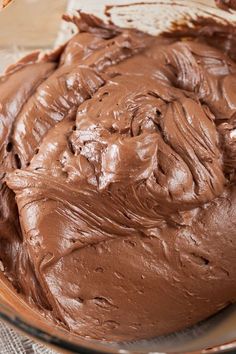 a close up view of chocolate frosting in a bowl