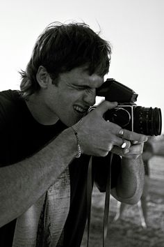 a man holding a camera up to his face