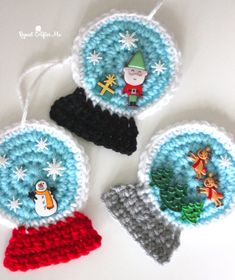 three crocheted ornaments are hanging on a white table with snowflakes and christmas decorations