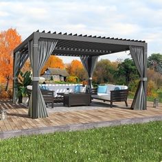 a gazebo sitting on top of a wooden deck next to a lush green field