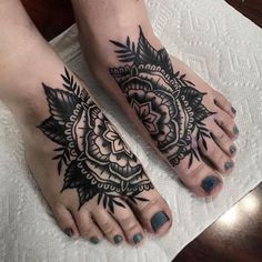 two feet with black and white tattoos on them, one has a flower in the middle