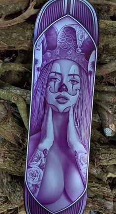 a purple skateboard with a woman's face painted on it