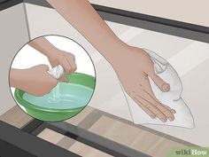 a person wiping their hands with a cloth on a dishwasher's glass door