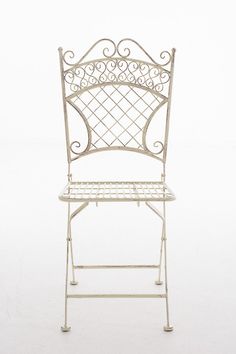 a white wrought iron garden chair against a white background with clippings on the seat