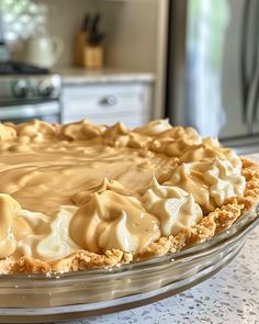 a pie with frosting sitting on top of a table