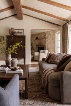 a living room filled with furniture and a fire place