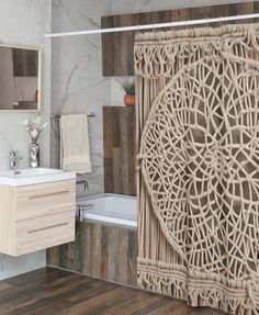 a bathroom with a shower, sink and bathtub covered in wicker curtaining