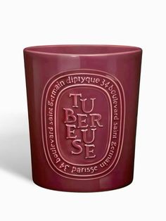 a red glass cup with the words tu ber jese in white lettering on it