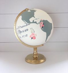 the globe is decorated with flowers and words