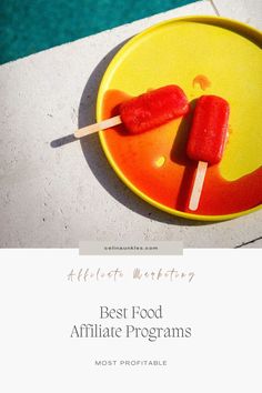 two popsicles sitting on top of a yellow plate next to a swimming pool with the words best food ampliate programs