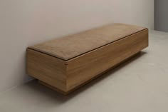 a wooden bench sitting on top of a white floor