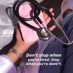 a person holding a pink heart shaped box with a stethoscope on it