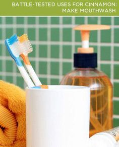 two toothbrushes are sitting in a cup next to a towel and soap dispenser