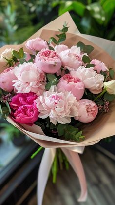 a bouquet of pink and white flowers on a table