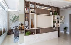 a living room filled with lots of furniture and decor on top of it's shelves