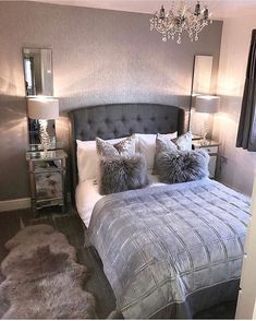 a bedroom with a bed, nightstands and chandelier