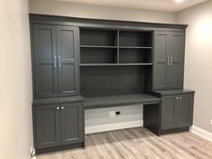 an empty room with gray cabinets and white walls