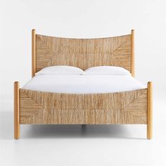 a bed made out of wood and white sheets