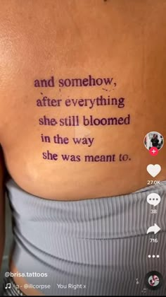 the back of a woman's stomach with words written on it and an image of a