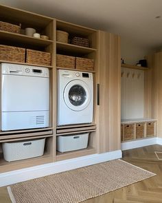 a washer and dryer in a room with wooden shelves