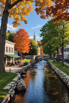 a river running through a small town surrounded by trees