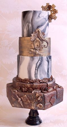 a three tiered cake with intricate designs on it