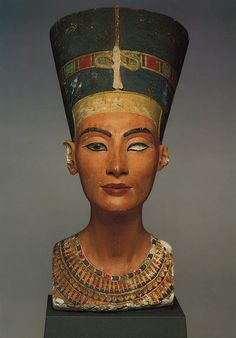 the bust of an egyptian queen wearing gold and black jewelry, with her head tilted to the side