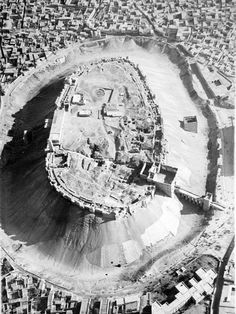 an aerial view of a city with lots of buildings and water in the middle of it