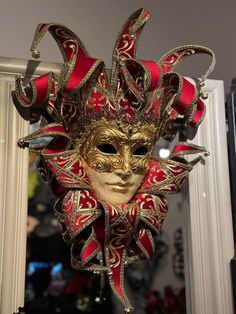 Beautiful Original Venetian jester mask made of paper mache (papier mâché). The face of the Jester mask is decorated with gold, antique crackling and a gold trim. The Pointed headpiece is made of red velvet and it has golden bells. This is a piece of art for your wall. also it can be used for carnival, bal masque, costumed ball and theme parties. exclusive wall decoration and a unique holiday gift and holiday ornament. This is a unique piece of art. The real Venetian carnival mask. Venetian Jester, Venetian Masks Art, Italian Masks, Venetian Costumes, Jester Mask, Mask Full Face, Venetian Carnival Masks, Costume Ball, Venetian Masks