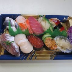 sushi platter with various types of sashimi and other food items on it