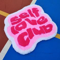 a pink and white sign that says self love club