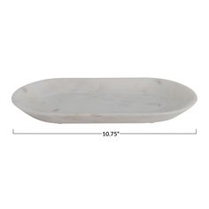 a white marble oval dish with measurements