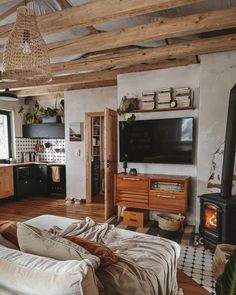 a living room filled with furniture and a flat screen tv on top of a wall