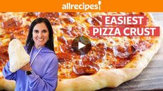 a woman holding a piece of pizza in front of an advertisement for allrecipes