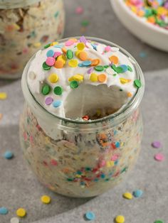 a jar filled with cake and sprinkles on top of a table