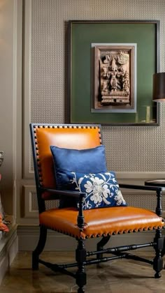 a living room with a chair, table and pictures on the wall