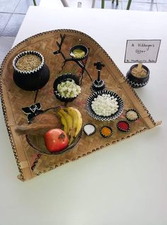 an assortment of food is displayed on a tray with a sign in the back ground