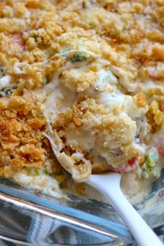 a casserole dish with broccoli, cheese and other toppings on it