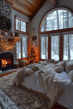 a bedroom with a fireplace and large windows